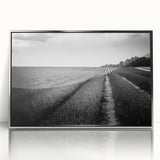 Framed acrylic wall art showcasing a vibrant landscape scene of lush green fields and a clear blue sky, designed for modern home decor. The elegant silver frame adds a sophisticated touch, enhancing the overall aesthetic appeal.