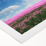 Vibrant rolled canvas wall art showcasing a serene landscape with lush green fields and a dramatic sky, ideal for home decor and artistic inspiration.