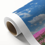 Vibrant rolled canvas art depicting serene landscapes and fields, showcasing lush greenery and a clear blue sky, perfect for home decor enhancement.