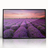 Framed wall art featuring a vibrant landscape design with fields and abstract patterns, displayed in a sleek black frame, ideal for enhancing modern home decor.