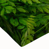 Close-up of a vibrant stretched canvas wall art piece showcasing a modern landscape garden design with rich greens and blues, perfect for home decor.