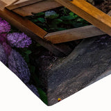 Close-up of a stretched canvas wall art piece showcasing a vibrant landscape garden design, featuring rich greens and floral details that enhance home decor aesthetics.