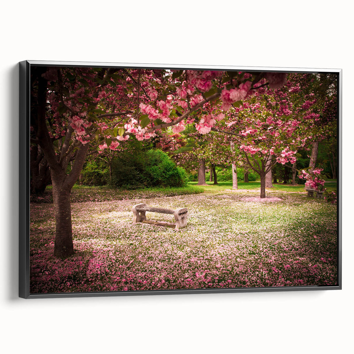 Framed canvas wall art showcasing a vibrant landscape garden design, featuring rich colors and intricate details, presented in a sleek black frame from a side view.