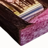 Close-up of a stretched canvas artwork showcasing a vibrant landscape design with lush greenery and colorful flowers, ideal for enhancing garden-themed decor.