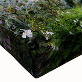 Close-up of a vibrant stretched canvas wall art piece showcasing a beautiful garden landscape design with lush greenery and colorful flowers, ideal for home decor.