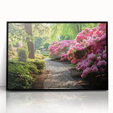 Framed acrylic wall art featuring a vibrant landscape design with lush greenery and colorful flowers, displayed in a sleek black frame, perfect for home decor.