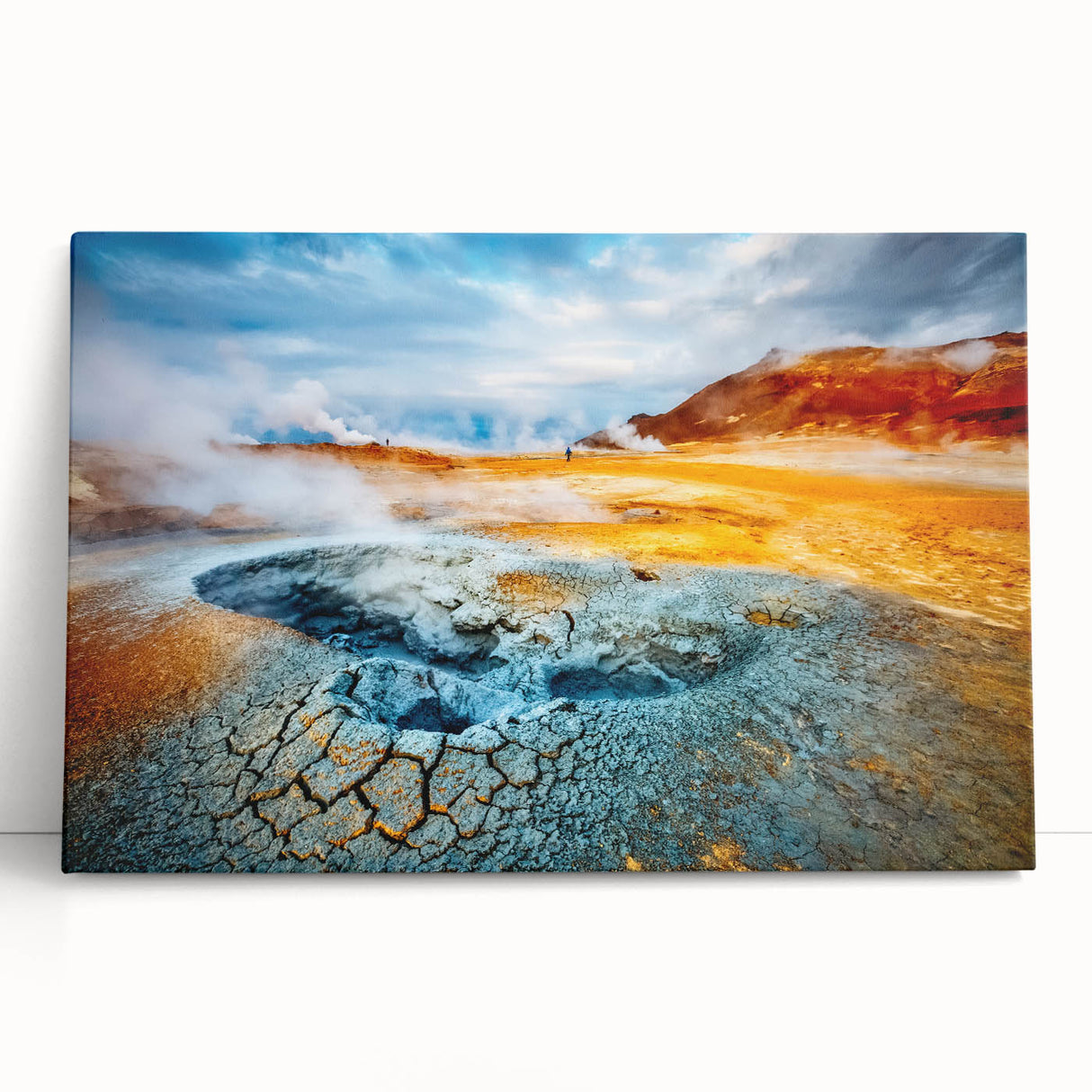 Stretched canvas wall art showcasing a vibrant landscape design featuring a geyser, leaning against a neutral wall, ideal for modern home decor.