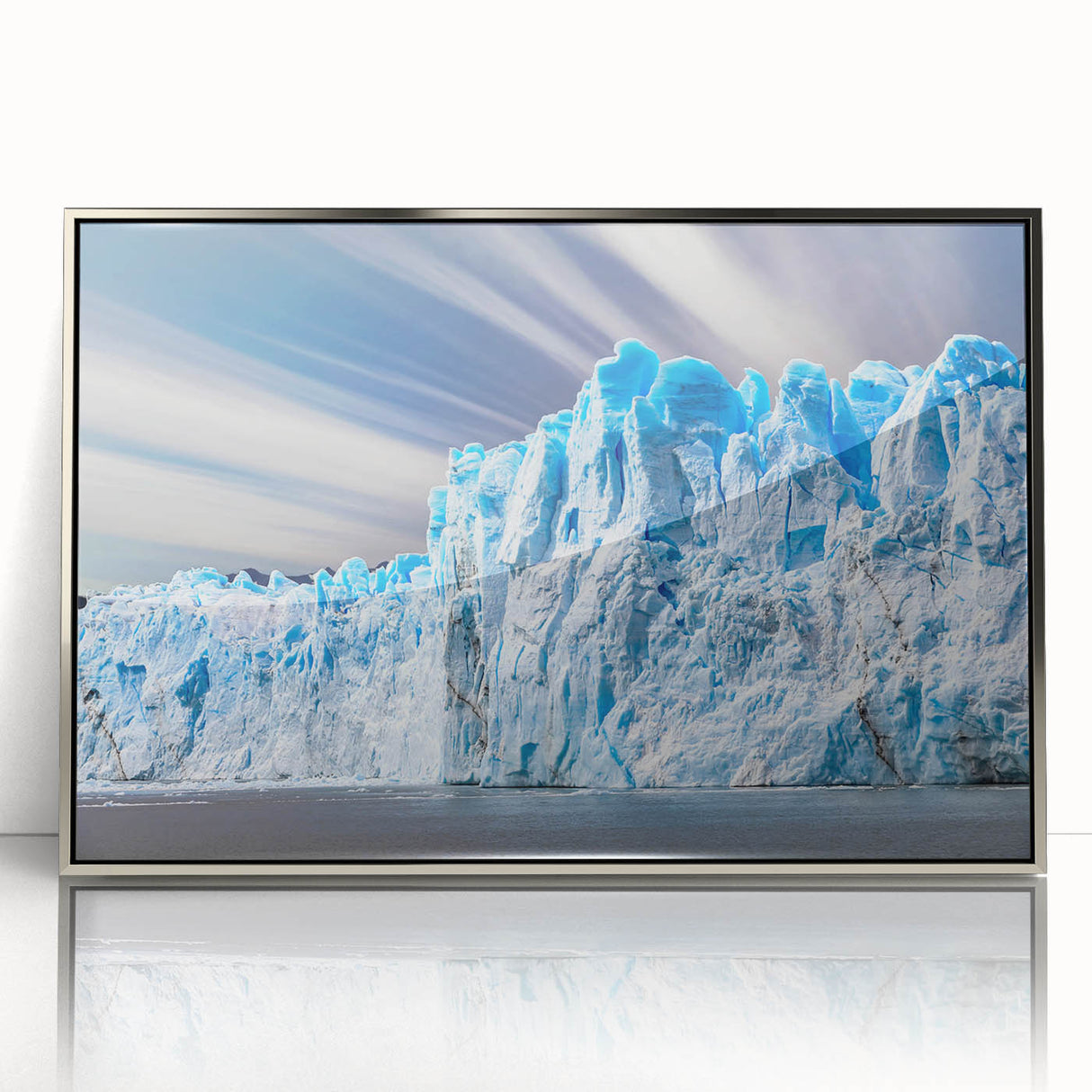 Framed acrylic wall art featuring a stunning glacier landscape design, showcasing shades of blue and white, perfect for modern home decor. The piece is highlighted with a sleek silver frame that enhances its aesthetic appeal.