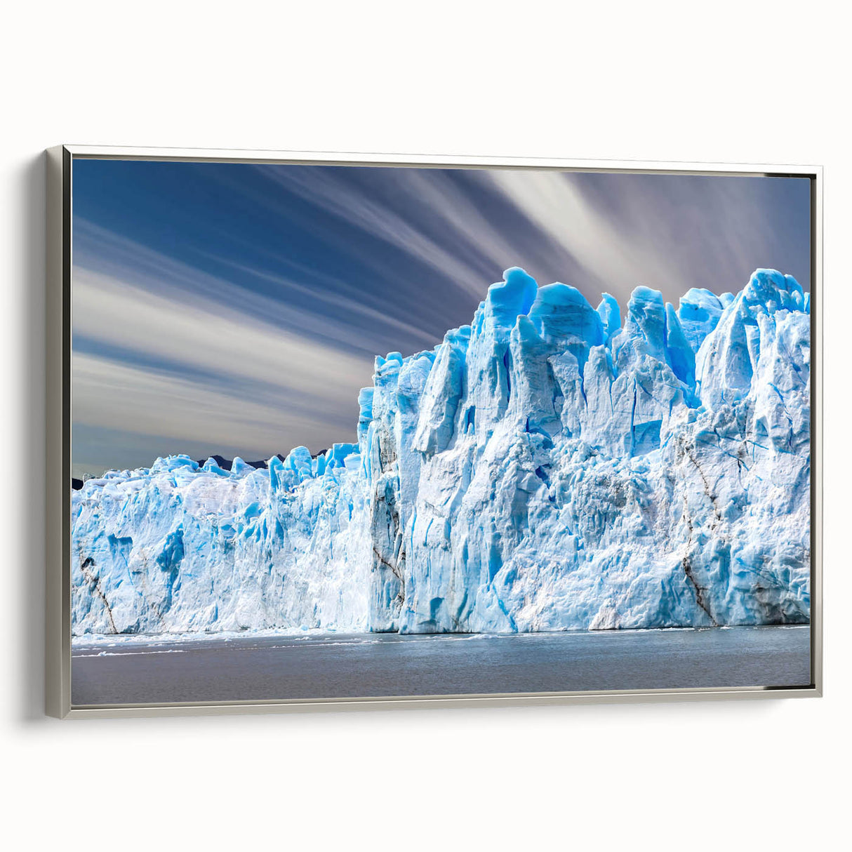 Framed canvas wall art showcasing a stunning glacier landscape design with a silver frame, perfect for enhancing modern home decor. The artwork captures the serene beauty of icy blue tones and intricate details, ideal for nature enthusiasts.