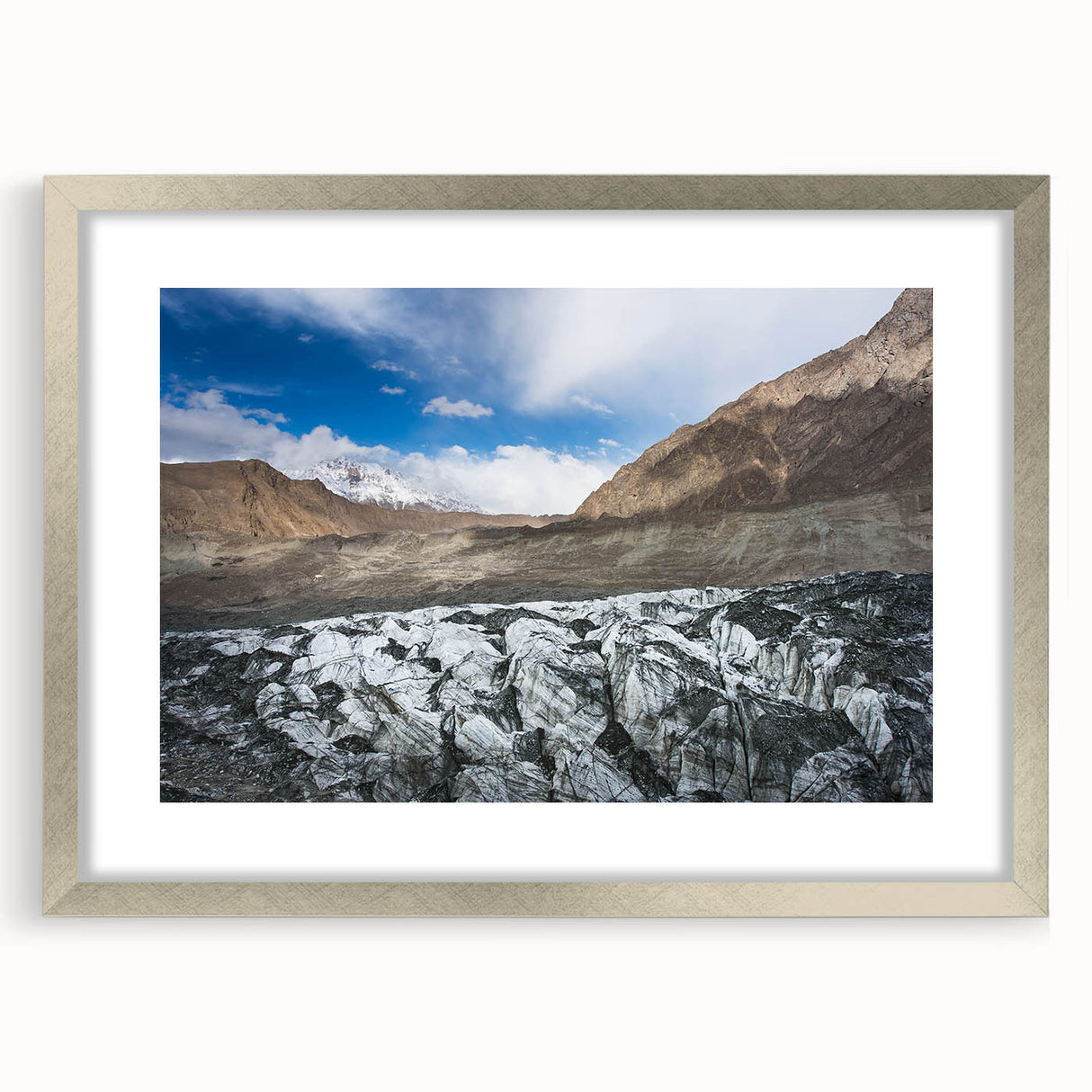 Framed wall art featuring a stunning glacier landscape design, set in a sleek silver frame with a white mat, ideal for modern home decor.