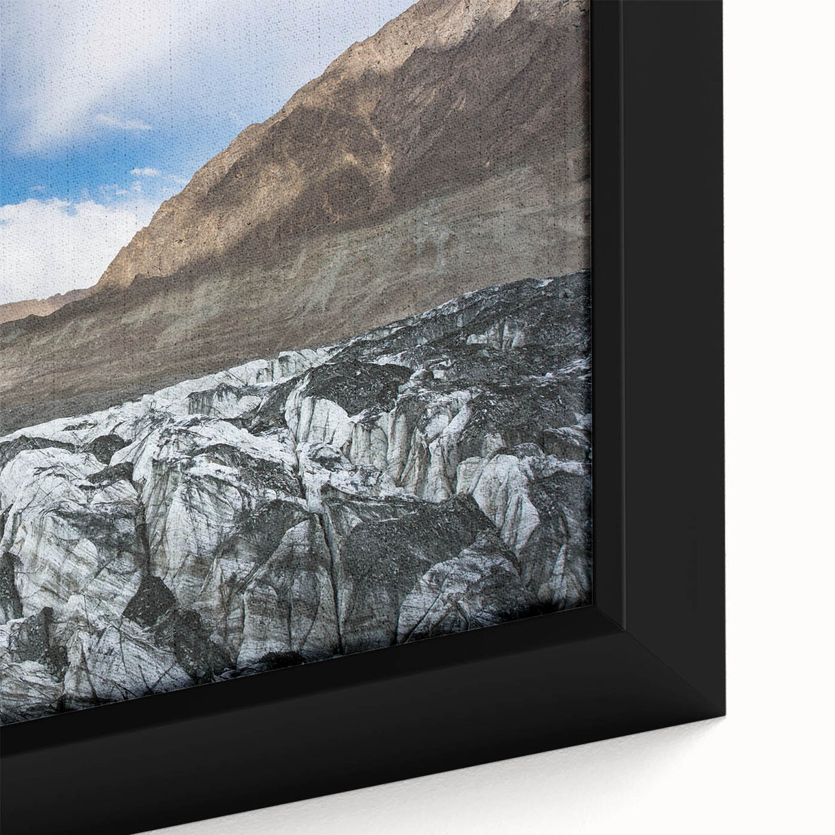 Close-up of a framed canvas wall art piece showcasing a stunning glacier landscape design, featuring vibrant blues and whites, perfect for home decor.