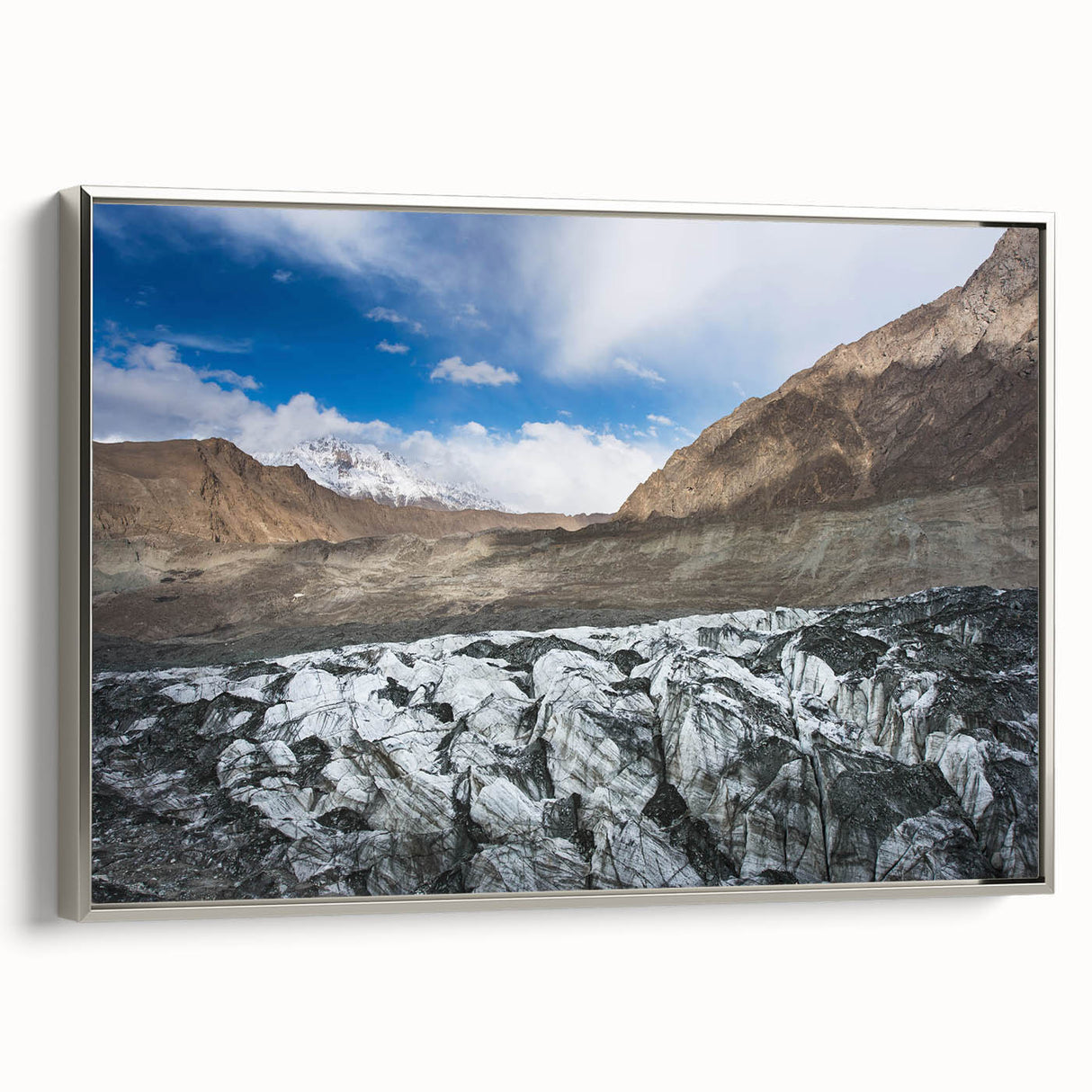 Framed wall art featuring a stunning glacier landscape design, presented in a sleek silver frame, showcasing ice formations and serene blue hues, perfect for nature enthusiasts.