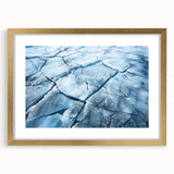 Framed wall art featuring a stunning glacier landscape design with a gold mat, showcasing serene icy blues and whites, ideal for modern home decor.