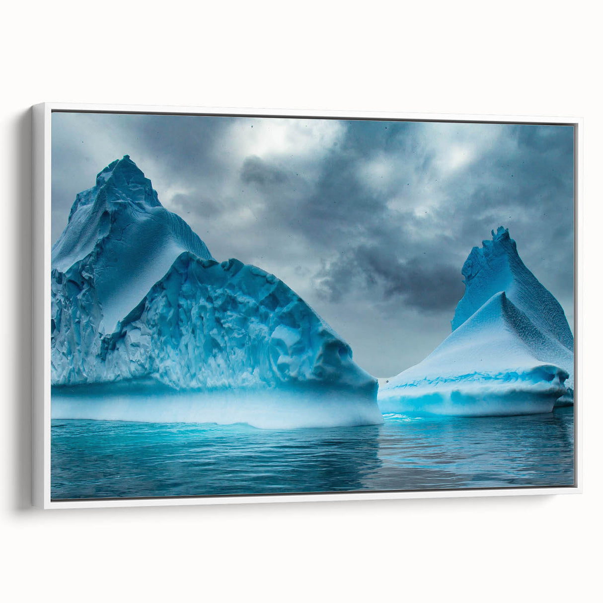 Framed canvas wall art showcasing a stunning glacier landscape design in vibrant blue and white tones, elegantly displayed with a white frame, enhancing modern decor.