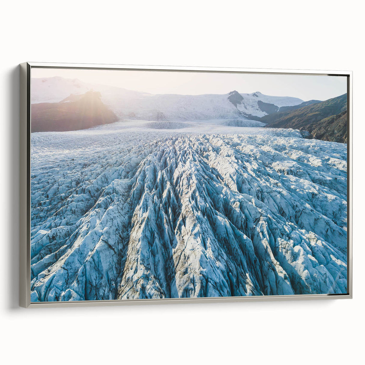 Framed canvas wall art showcasing a stunning glacier landscape design, featuring cool blue and silver tones, mounted elegantly for modern decor aesthetics.
