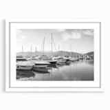 Framed landscape wall art collection showcasing a serene harbor scene, featuring calming blues and whites, perfect for modern home decor. The piece includes a white mat for an elegant finish, enhancing its visual appeal in any living space.