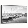 Framed canvas wall art of a serene harbor landscape, showcasing vibrant colors and intricate details, presented in a sleek black frame for modern decor.