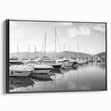 Framed canvas wall art of a serene harbor landscape, showcasing vibrant colors and intricate details, presented in a sleek black frame for modern decor.