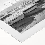 Rolled canvas depicting a serene harbor landscape with soft pastel colors and intricate details, ideal for home decor, packaged in protective cardboard tube.