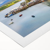 Rolled canvas showcasing a serene harbor landscape design, featuring tranquil blue waters and vibrant sky hues, packaged securely in a protective cardboard tube.