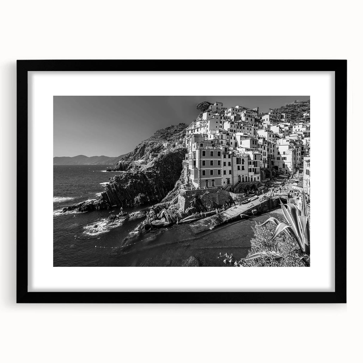 Framed black wall art featuring a serene harbor landscape design, accented by a white mat, perfect for modern home decor and enhancing interior aesthetics.