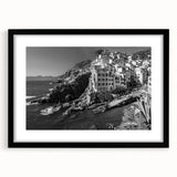 Framed black wall art featuring a serene harbor landscape design, accented by a white mat, perfect for modern home decor and enhancing interior aesthetics.