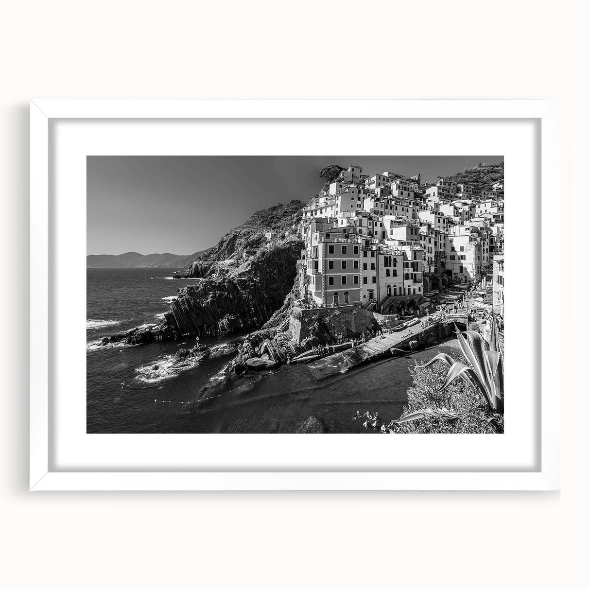 Framed wall art featuring a serene harbor landscape design, highlighted by a white mat and sleek black frame, perfect for modern decor in living spaces.