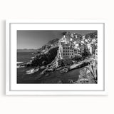 Framed wall art featuring a serene harbor landscape design, highlighted by a white mat and sleek black frame, perfect for modern decor in living spaces.
