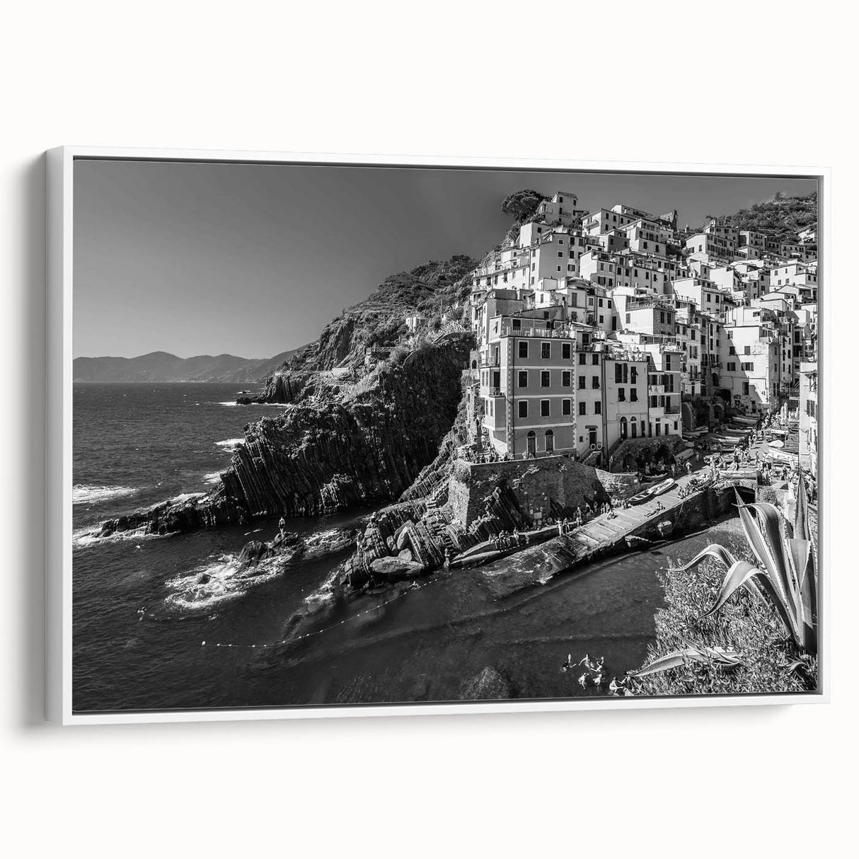 Framed canvas wall art showcasing a serene harbor design in soft hues of blue and white, presented in a sleek white frame, ideal for coastal-themed decor.