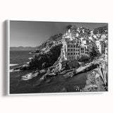 Framed canvas wall art showcasing a serene harbor design in soft hues of blue and white, presented in a sleek white frame, ideal for coastal-themed decor.