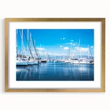 Elegant wall art frame showcasing a coastal harbor landscape design with a gold mat, perfect for enhancing home decor in living spaces or offices.