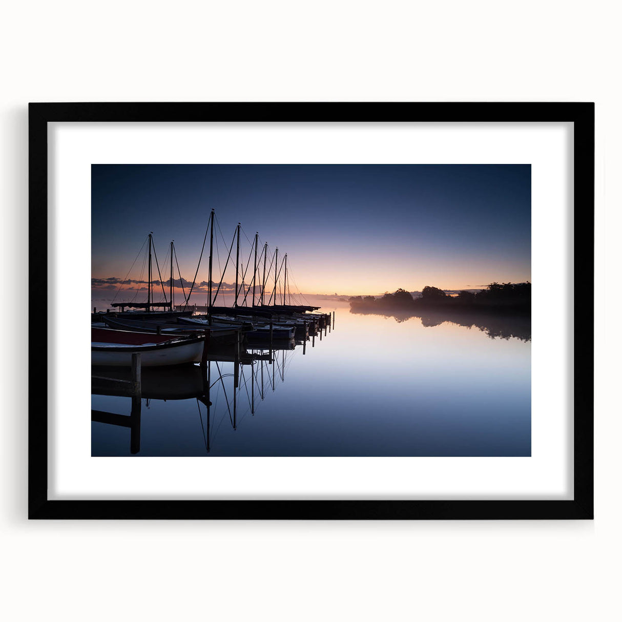 Framed wall art showcasing a serene harbor landscape design with a black mat, ideal for home decor, adding elegance and tranquility to any room.