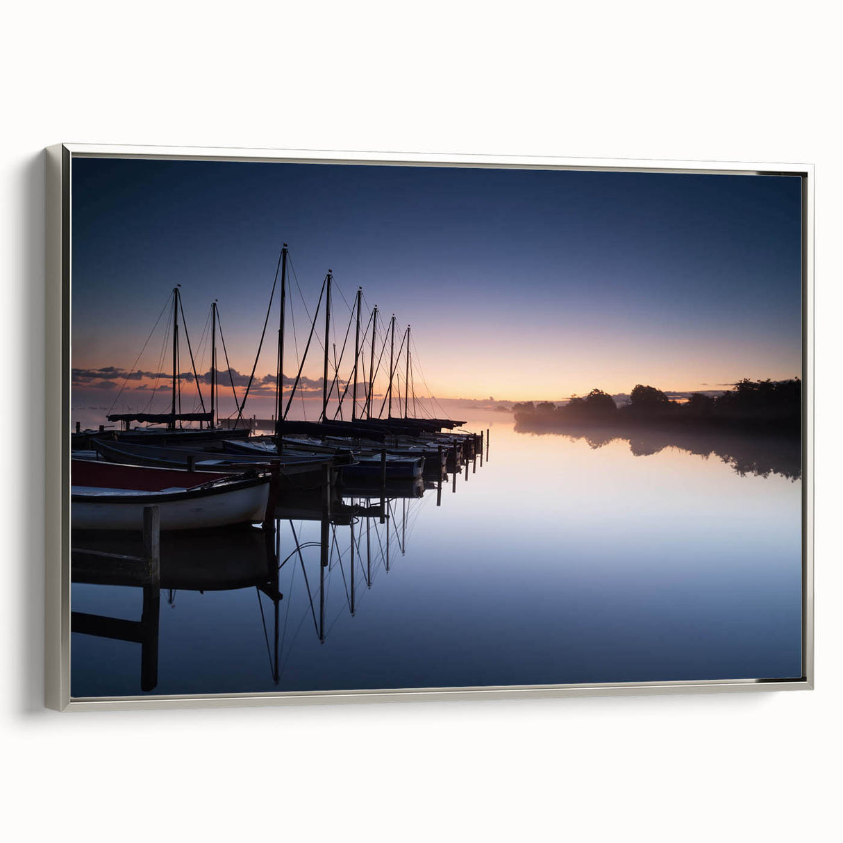Framed wall art featuring a serene harbor landscape design with silver accents, showcasing tranquil waters and a picturesque sky, perfect for home decor.