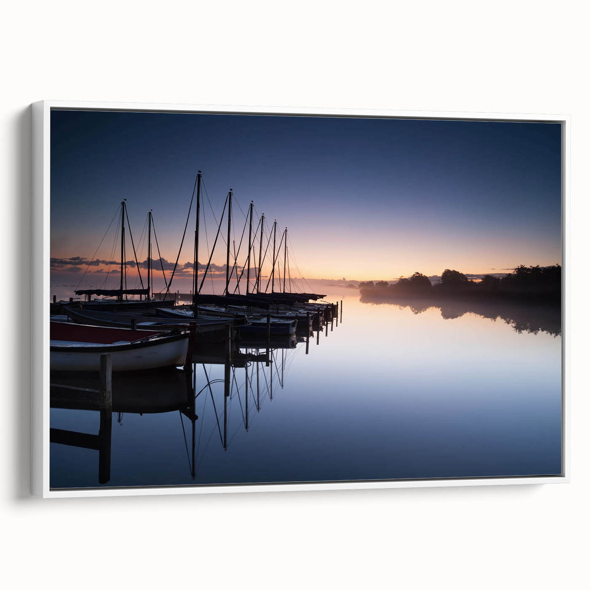 Framed canvas wall art depicting a serene coastal harbor scene with vibrant blues and greens, set against a white background, perfect for home décor.