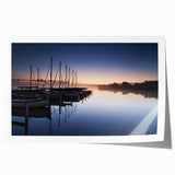 Rolled print of a serene harbor landscape featuring soft pastel colors, ideal for home decor, showcasing calm waters and boats against a sunset sky.