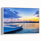 Framed canvas wall art depicting a serene harbor landscape, featuring tranquil blue waters and soft pastel skies, elegantly displayed with a white frame.