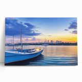 Stretched canvas artwork showcasing a serene harbor landscape design, featuring calming blues and greens, elegantly leaning against a neutral wall, ideal for home decor.