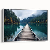 Framed canvas artwork showcasing a serene harbor landscape, featuring soft blue and green tones, positioned at an angle against a white wall, ideal for home decor.