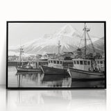 Framed acrylic wall art featuring a serene harbor landscape with vibrant blue waters and lush greenery, elegantly displayed in a sleek black frame, perfect for modern home decor.