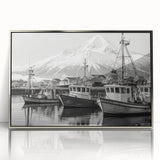 Framed acrylic wall art featuring a serene harbor landscape with tranquil blue waters and vibrant sunset hues, elegantly displayed with a sleek silver frame.
