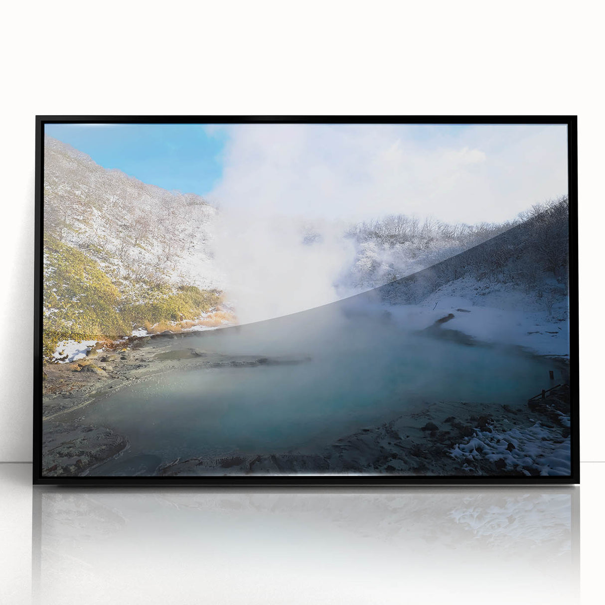 Framed acrylic wall art featuring a serene hot spring landscape design with vibrant greens and blues, presented in a sleek black frame, ideal for modern decor.