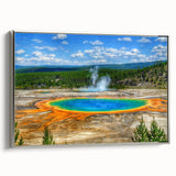 Framed canvas wall art depicting a serene hot spring landscape with lush greenery and soft blue water, accented by a sleek silver frame, ideal for modern decor.