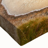 Close-up of a vibrant, stretched canvas wall art piece showcasing a serene hot spring landscape, featuring lush greenery and tranquil water, ideal for home decor.