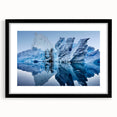 Framed black wall art showcasing a stunning iceberg landscape design, featuring vibrant blue and white tones with a sleek mat for a modern home decor accent.