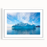 Framed iceberg landscape wall art with a white mat, showcasing serene icy blue tones and intricate details, ideal for modern home decor.
