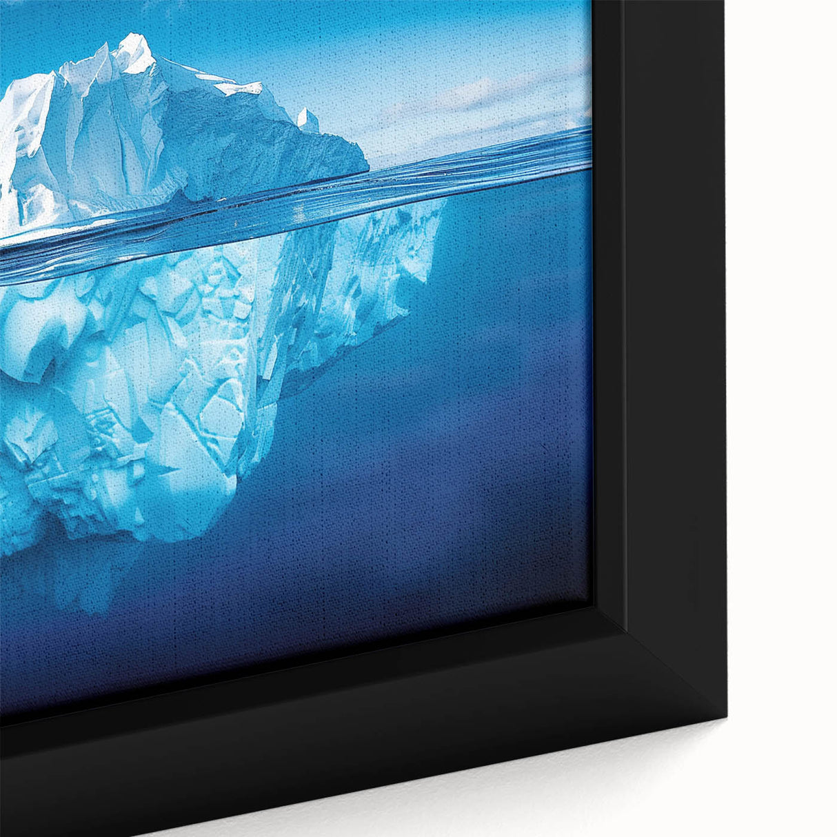 Close-up of a framed canvas art piece showcasing a vibrant iceberg landscape design, featuring shades of blue and white, perfect for modern home decor.