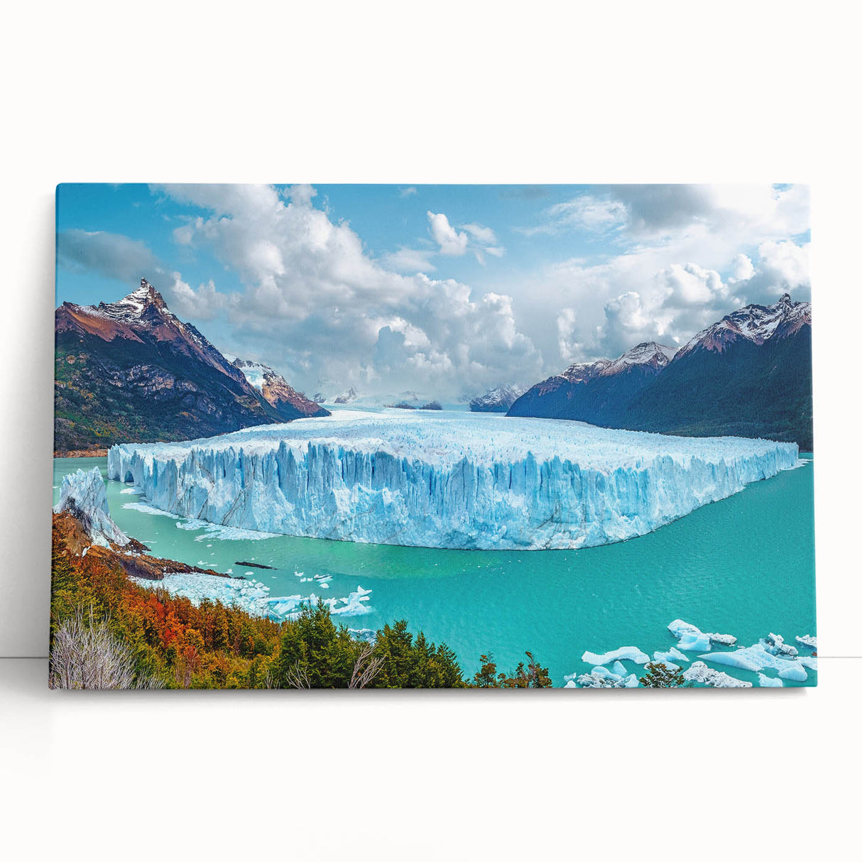 Stretched canvas artwork showcasing a striking iceberg landscape design with vibrant blue hues, ideal for modern home décor, leaning against a wall.