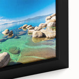 Framed canvas artwork showcasing a serene lake landscape with vibrant blues and greens, highlighting reflections in the water and surrounding nature, perfect for home decor.