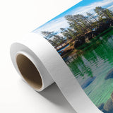 Rolled canvas print showcasing a serene landscape with tranquil lake and forest reflections, ideal for home decor, packaged securely in a protective tube.