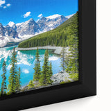 Framed canvas wall art showcasing a serene lake landscape with vibrant blue waters and lush greenery, ideal for home decor and nature enthusiasts.